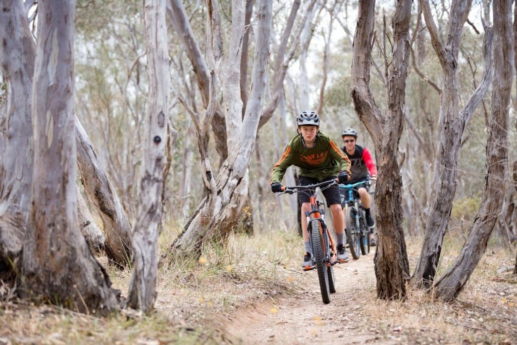 Two cyclists ride the mountain bike trails on Nail Can Hill, Albury.