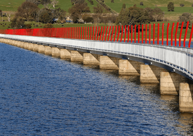 The sandy creek bridge spans an inlet of Lake Hume. This bridge is found on the High Country Rail Trail, a popular bike trail.