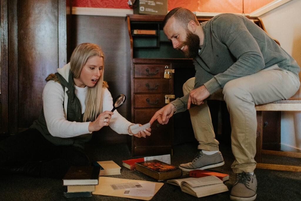 A man and a woman finding clues in an escape room