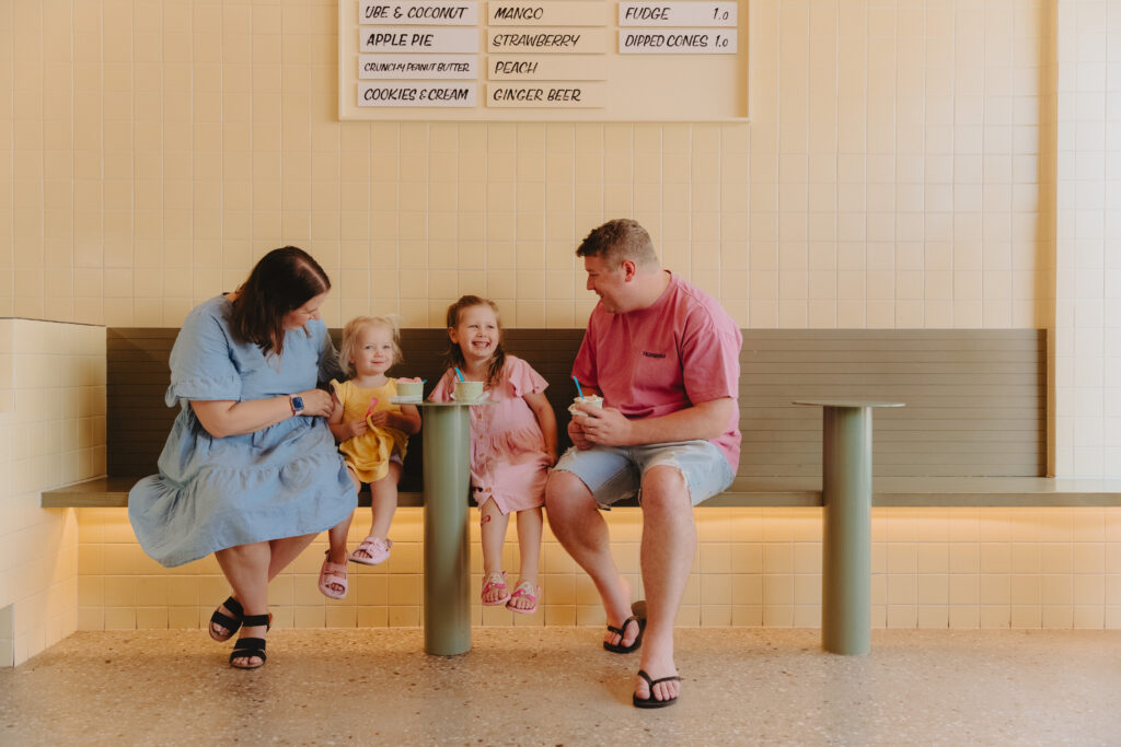 A family with two little girls in an ice cream shop