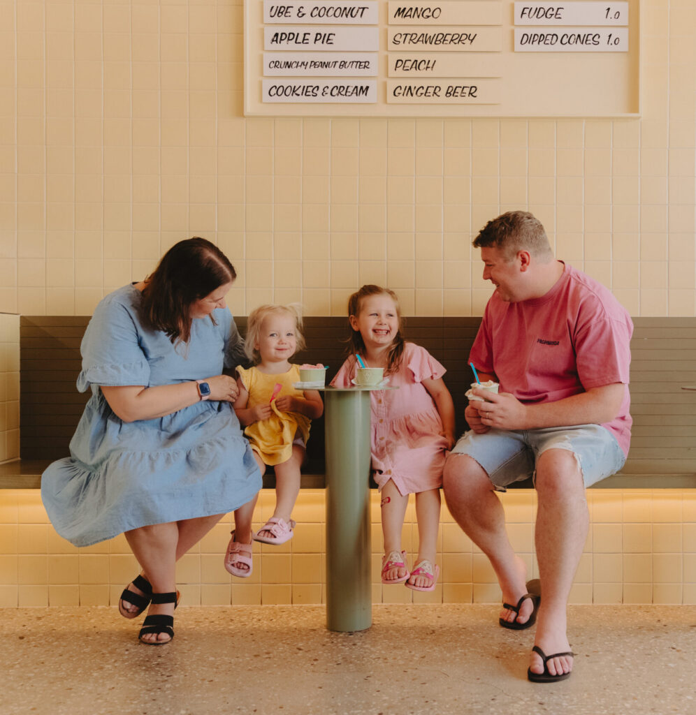 A family with two little girls in an ice cream shop