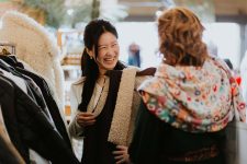 Two women looking at clothes in boutique store